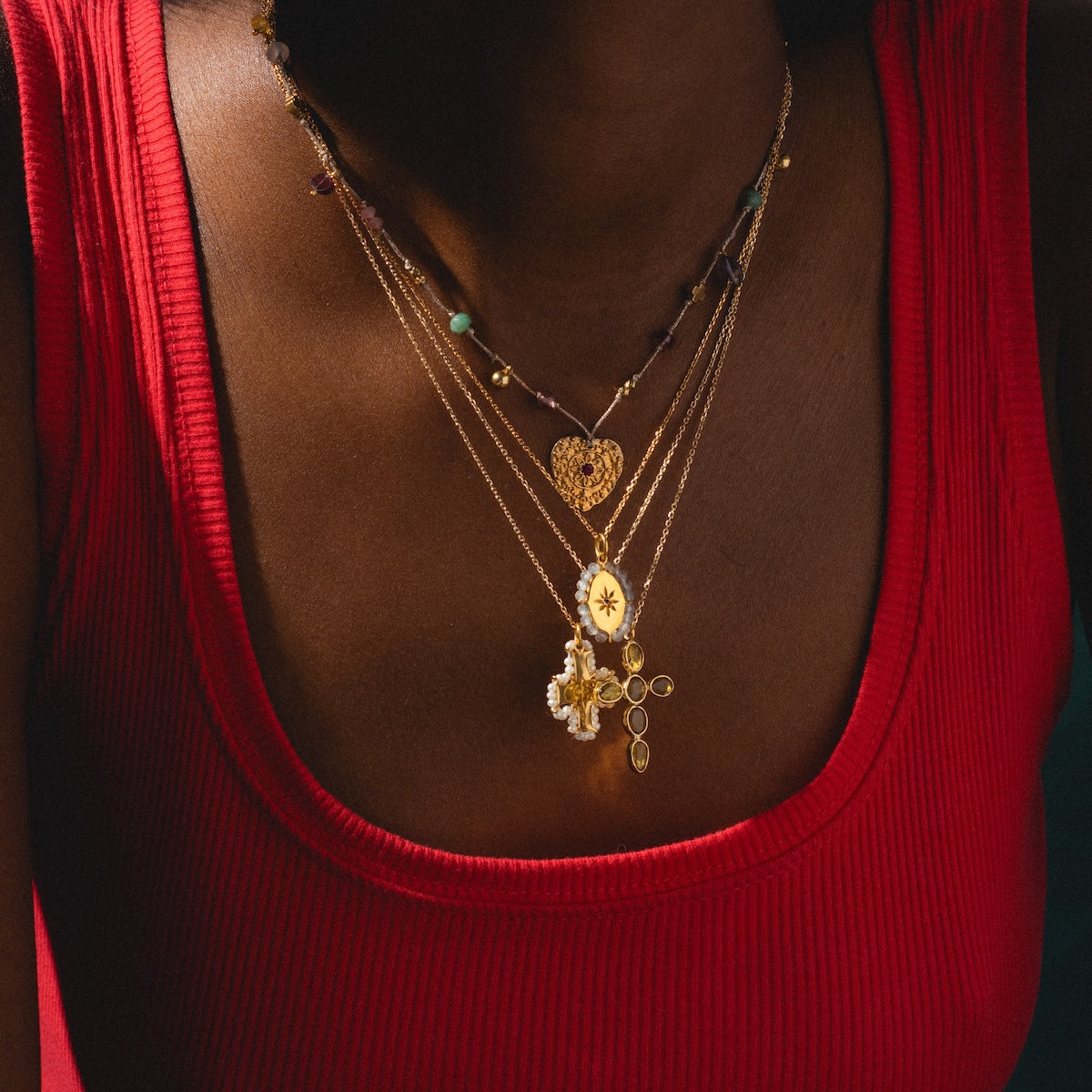 Woman wearing Marceau Necklace, and Karana Necklace in a stack with two other necklaces