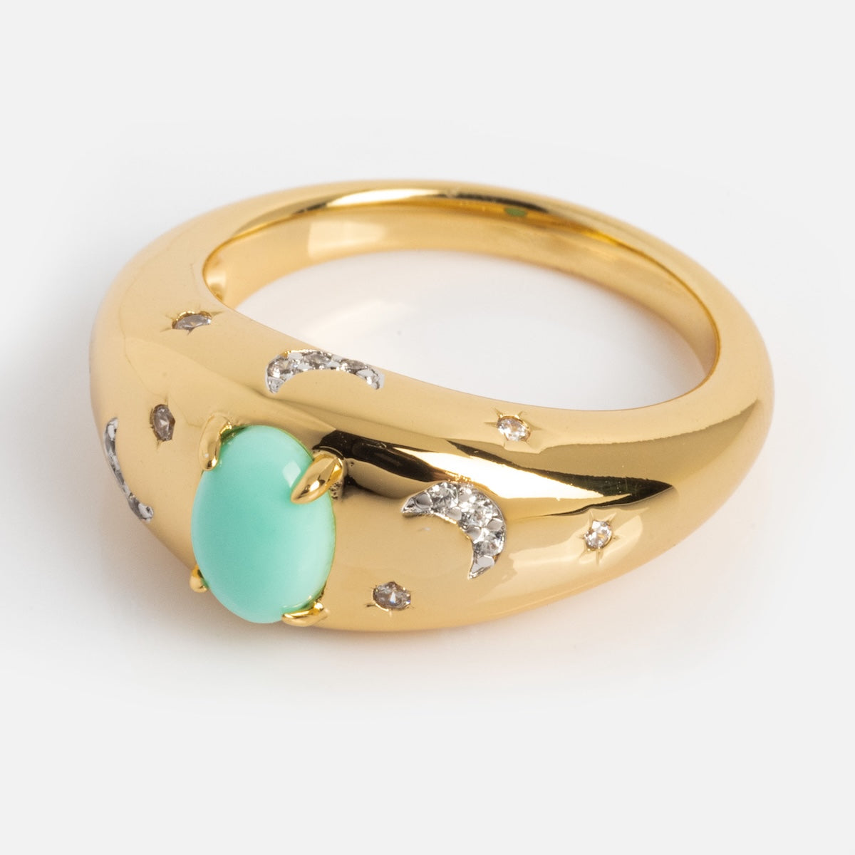 The Turquoise Sky Dome Ring features a gold-plated band with a central turquoise dome gemstone, accented by crescent moon and star-shaped diamond-like stones.