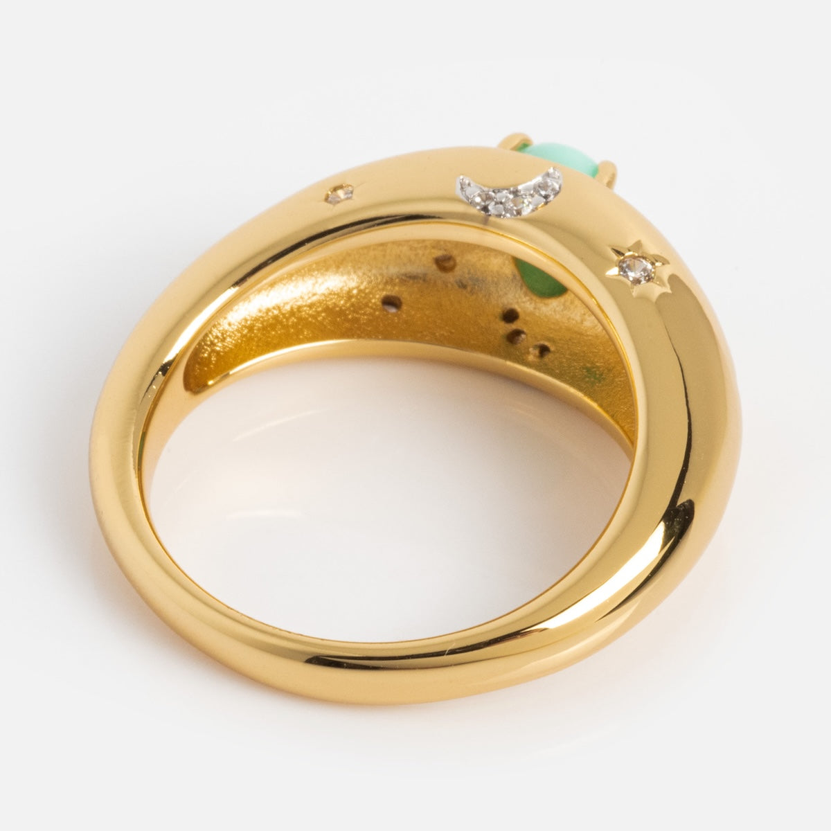 The Turquoise Sky Dome Ring features a smooth, curved gold-plated band with a diamond star and crescent moon engraved inside, and a partially visible turquoise gemstone at the top.