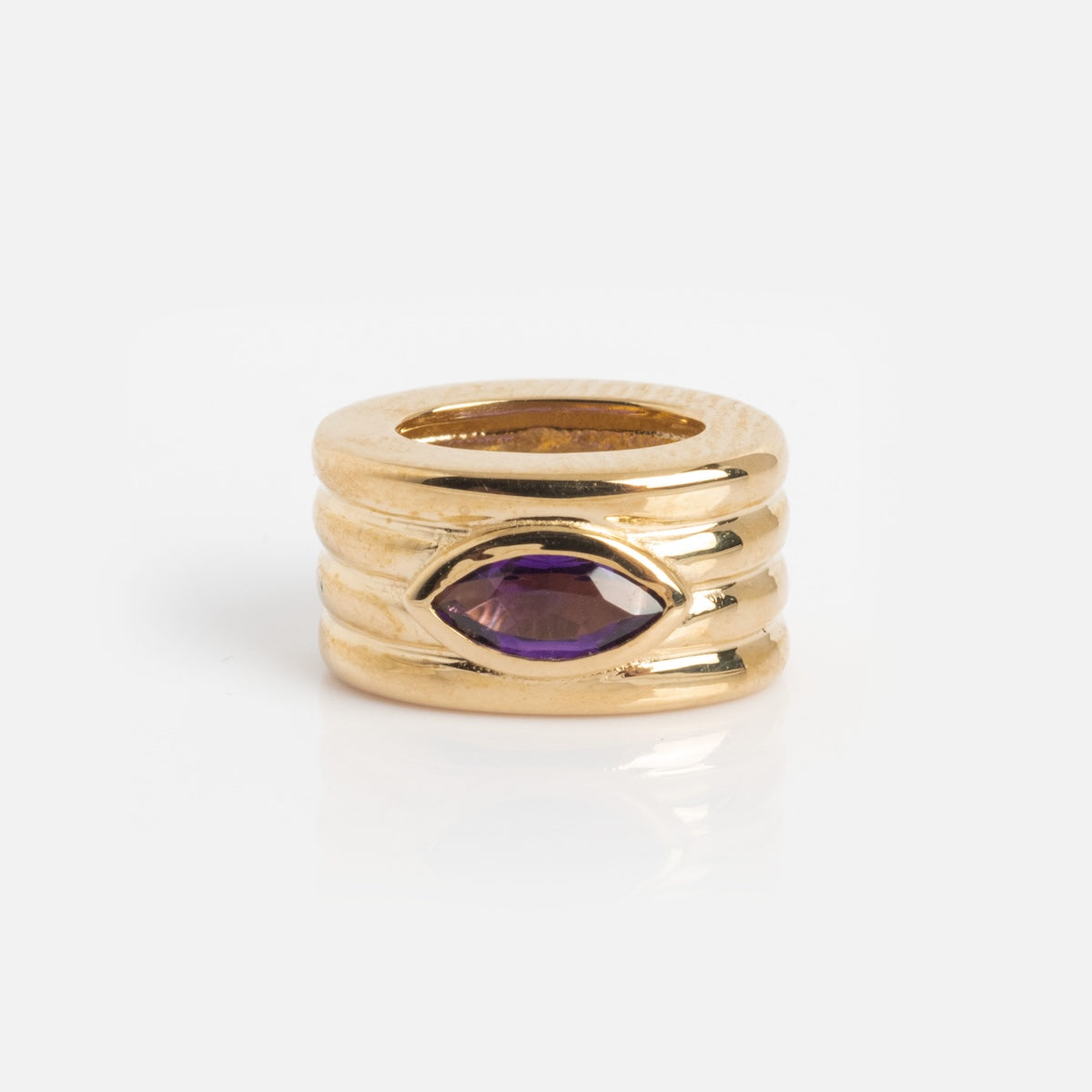 The Solid Gold Bold Birthstone Spacer Charm features a three-band gold design with a horizontally set marquise-cut purple gemstone at its center.