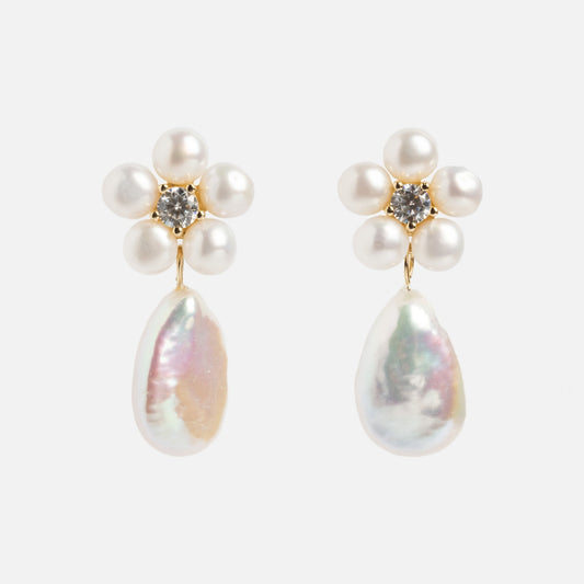 The Flower Pearl Drop Earrings feature a flower design with six round freshwater pearls, a central clear gemstone, and baroque pearl drops, all crafted in 14k gold vermeil and shown against a white background.