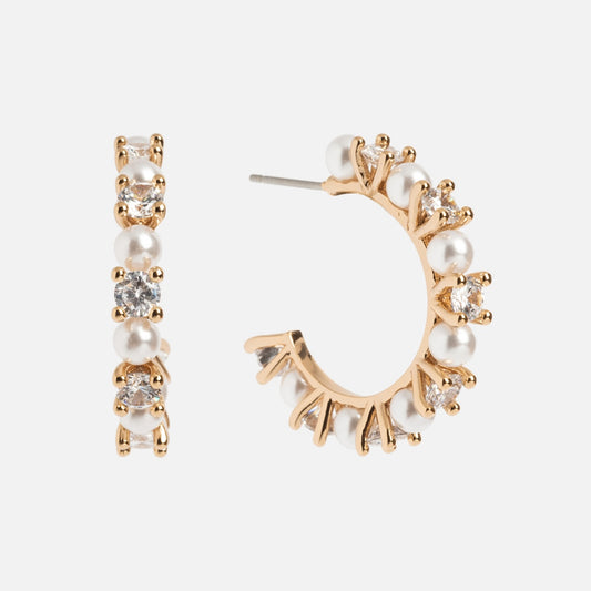 The Prive Hoops are gold plated earrings featuring alternating white pearls and clear gemstones. Displayed on a white background, one earring is shown from the front, the other from the side.