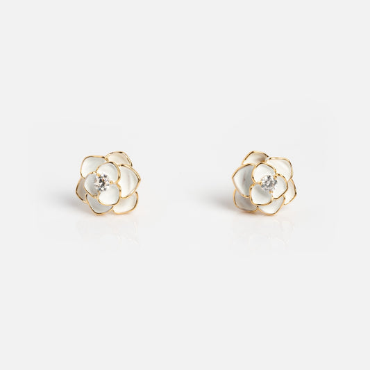 The Sparkling White Rose Studs are enamel earrings shaped like roses with white petals, gold outlines, and a central sparkling gemstone, shown against a plain white background.