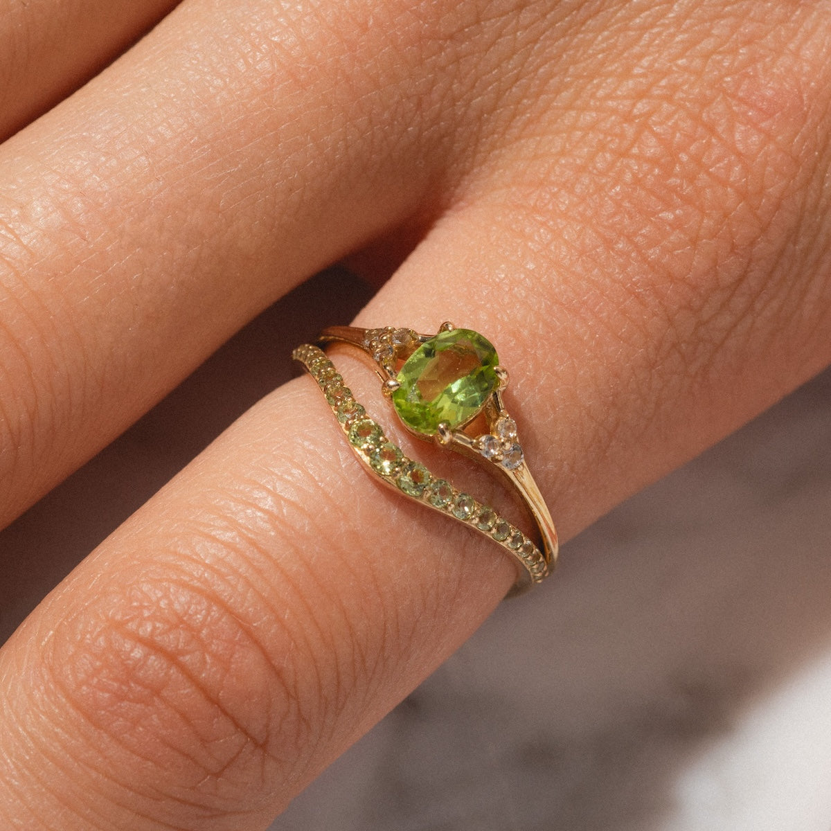 Peridot statement and stacking ring worn together on finger