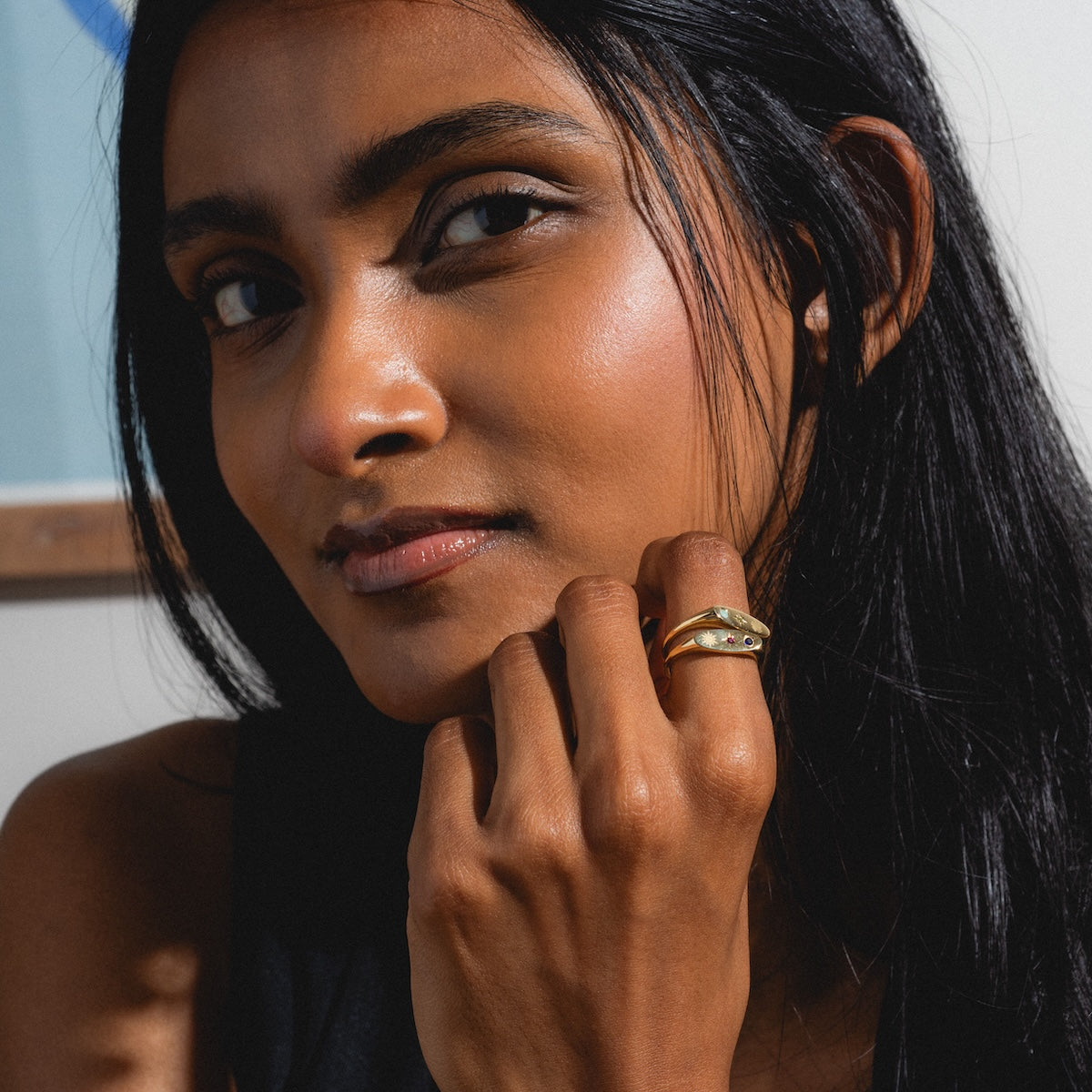 Woman with a gold manifestation rings on her finger