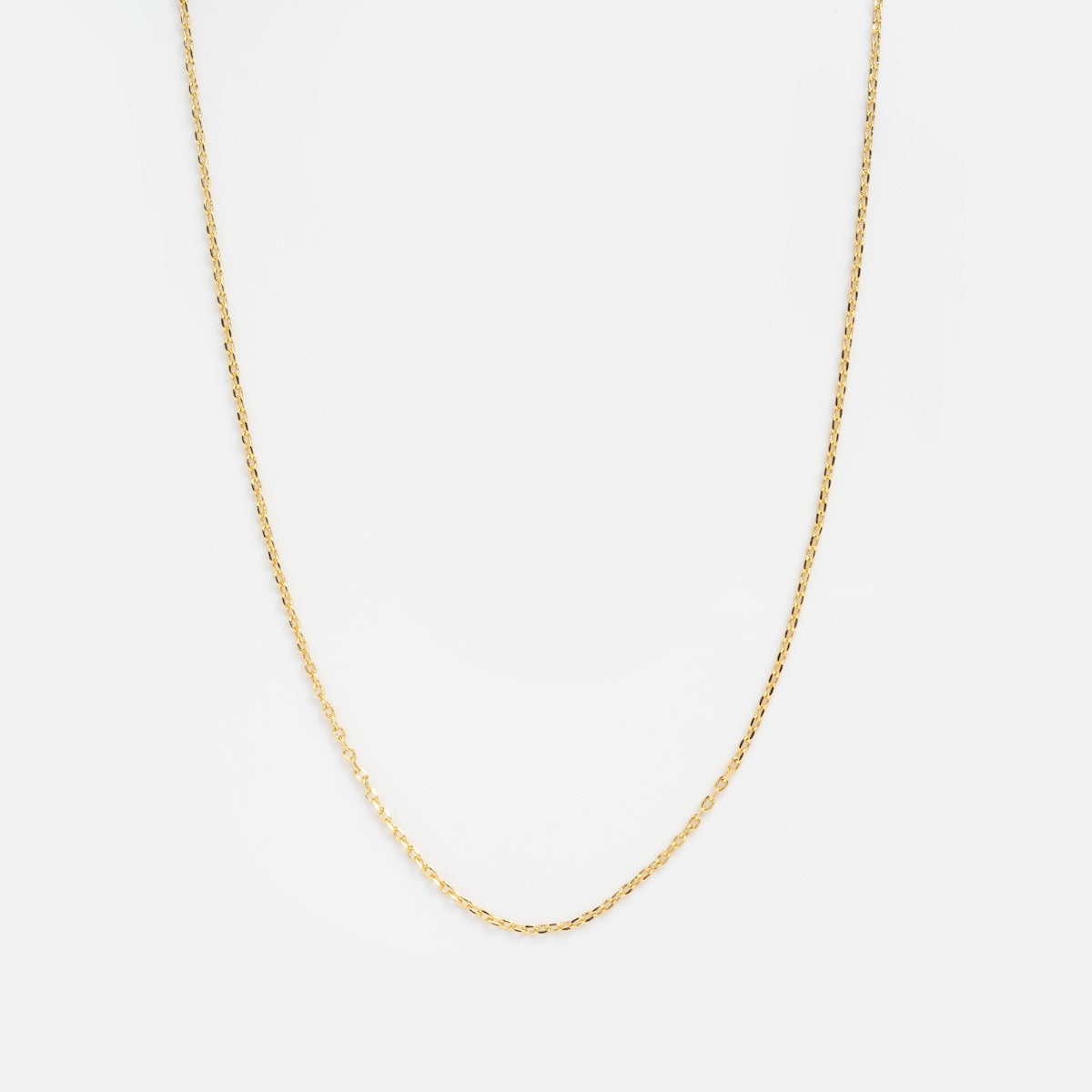 The Oval Link Chain is a delicate gold plated necklace, elegantly displayed on a plain white background—an ideal piece to enhance your charm collection.