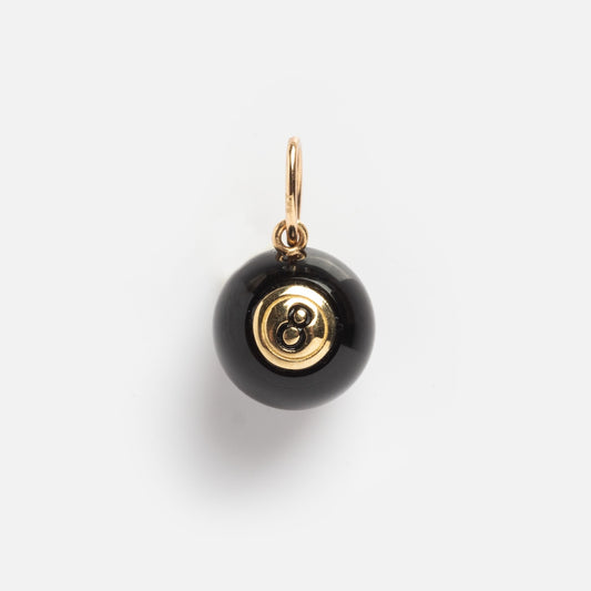 The Solid Gold Lucky Charm is a pendant shaped like a black eight ball with a gold top and loop for attaching to a chain, shown on a white background.