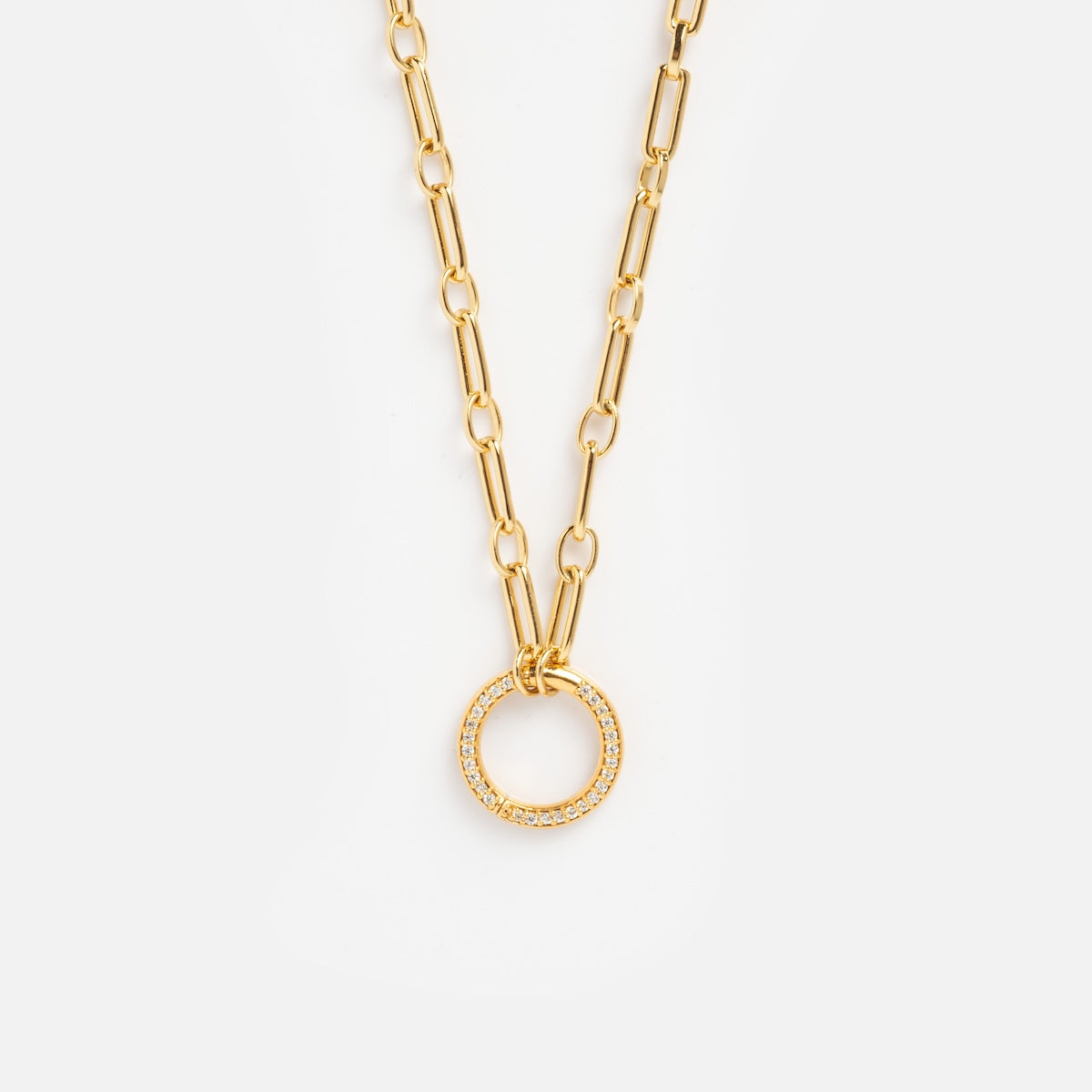 The Perfect Start Charm Holder Necklace is a gold-plated chain with elongated links and a circular pendant adorned with small clear gemstones, shown on a white background—ideal for displaying your favorite charms.