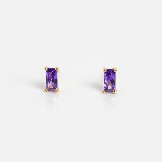 The Birthstone Baguette Studs February Sample features rectangular purple gemstone studs in gold prong settings, shown on a plain white background.