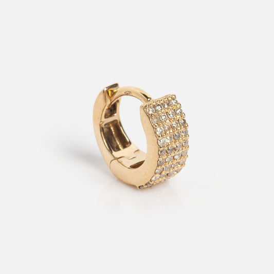 The Solid Gold Chunky Pave Diamond Huggie Hoops Sample features three rows of sparkling diamonds on a gold hoop, showcased against a plain white background.