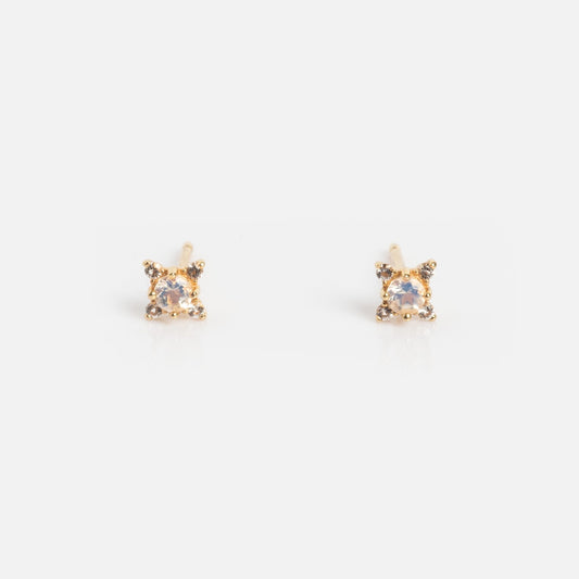 A pair of Solid Gold Moonstone Stud Earrings, each with a single round moonstone in a four-prong setting, displayed on a plain white background.