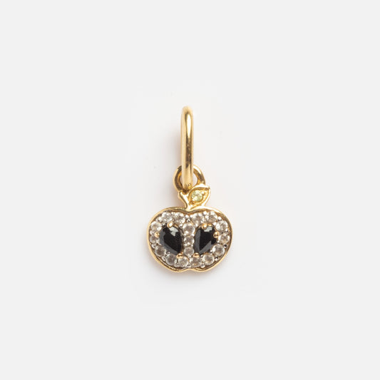 The Solid Gold Half Apple Charm Sample features a gold apple shape with two black center stones, small clear outlining stones, and is attached to a gold loop.