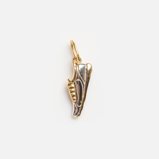 The Solid Gold Marathon Shoe Charm Sample is a small sneaker-shaped gold and silver pendant with a top loop for attaching to a chain, shown on a plain white background.
