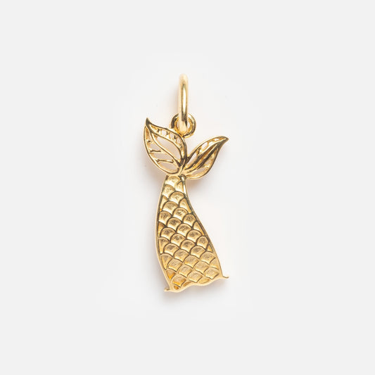The Solid Gold Mermaid Tail Charm Sample features a textured, scale-like pattern and a small loop for attaching to a chain, shown against a plain white background.