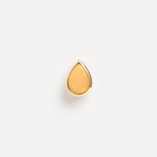 A solid gold pear-shaped slider charm with an Ethiopian opal gemstone centered, displayed on a plain white background.