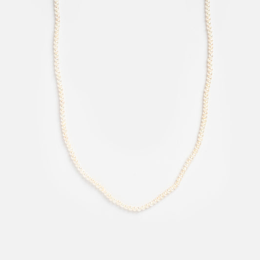 The Delicate Pearl Necklace Sample features a single strand of small white pearls, showcased against a plain white background.