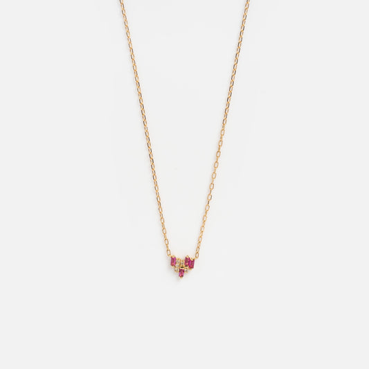 The Solid Gold Geometric Ruby and Sapphire Necklace Sample features a delicate yellow gold chain with a small geometric pendant accented by lab-created rubies in a subtle V shape, shown on a plain white background.