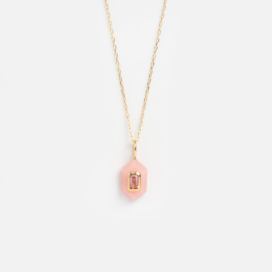 The Solid Gold Large Aura Necklace Pink Sample features a gold chain and a pink hexagon pendant with a rectangular gemstone at its center, shown on a plain white background.