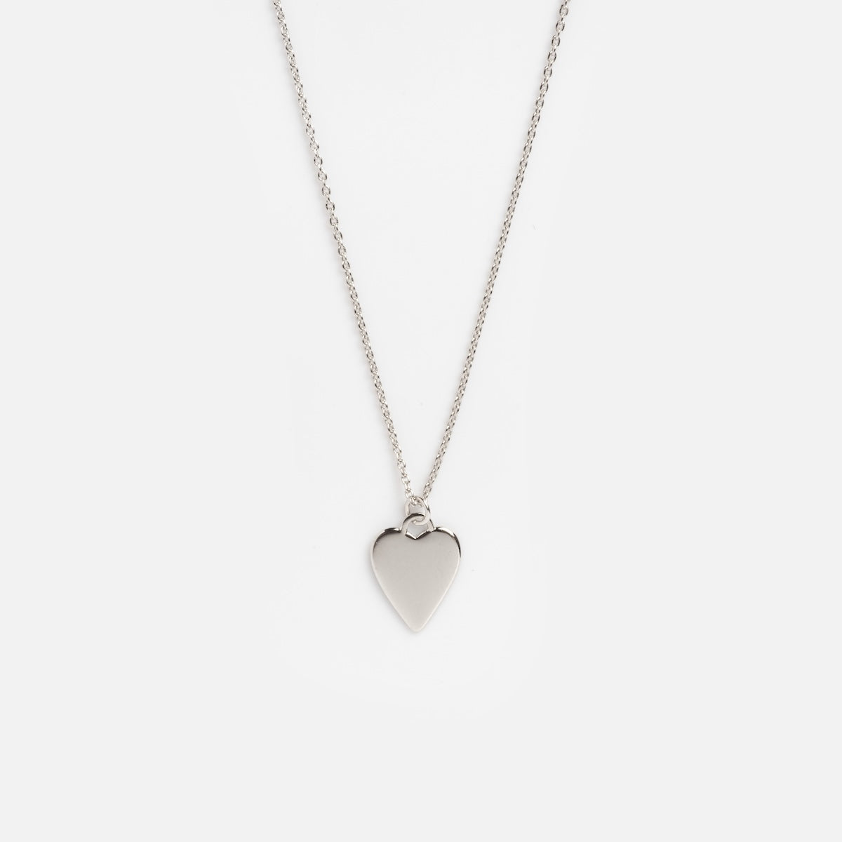The Silver Heart Charm Necklace Sample Size features a delicate silver chain with a smooth heart-shaped pendant, displayed on a plain white background.