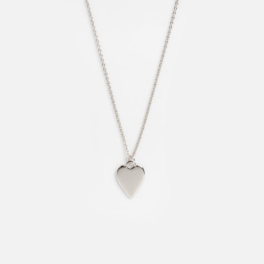 The Silver Heart Charm Necklace Sample Size features a delicate silver chain with a smooth heart-shaped pendant, displayed on a plain white background.