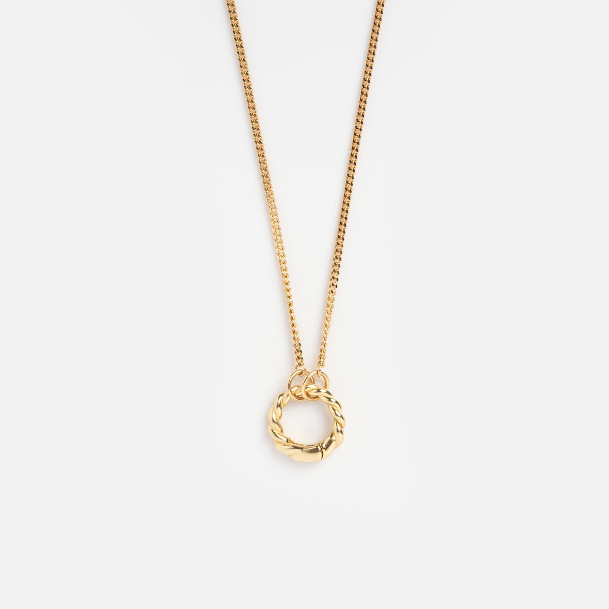 The Solid Gold Perfect Start Charm Holder Necklace features a thin chain and a circular, twisted rope-style pendant, displayed against a plain white background.