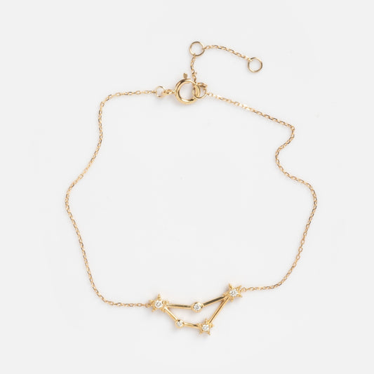 Solid Gold Zodiac Bracelet Capricorn Sample shown on a plain white background, featuring a delicate gold chain with a constellation design and small sparkling stones at each connecting point.