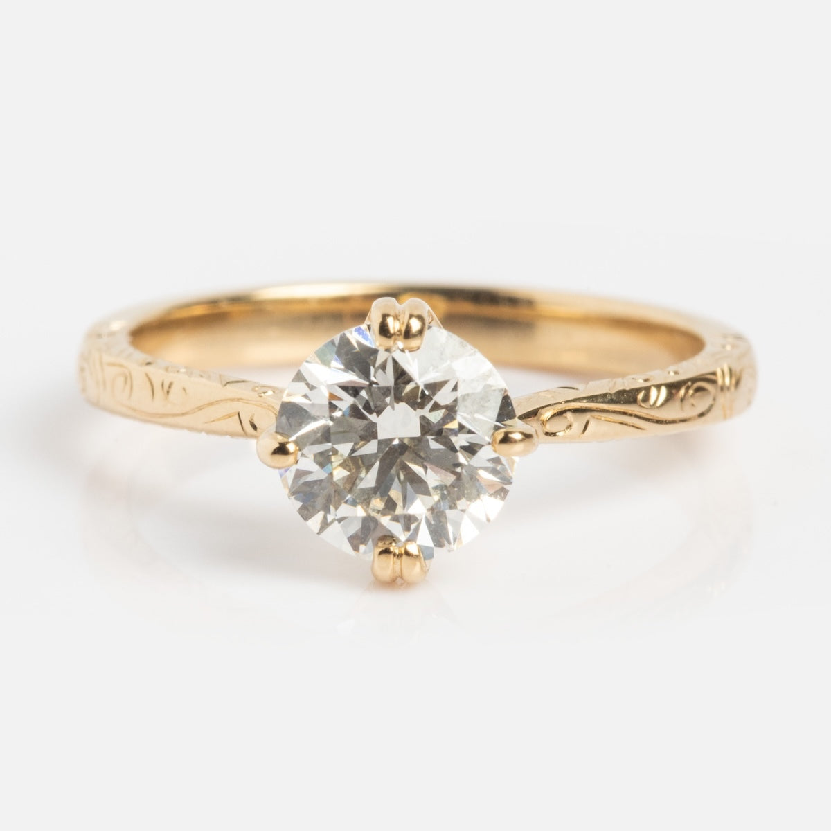 The Bespoke Design Consultation by Local Eclectic displays a custom gold engagement ring with an engraved band and brilliant-cut diamond in a four-prong setting, set against a plain white background.