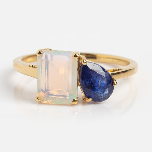 A customizable toi et moi ring featuring moonstone and blue sapphire, handcrafted in 9k solid yellow gold, sample size 7.