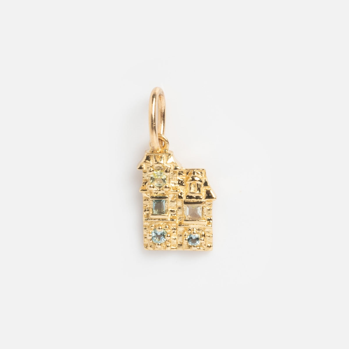 The Solid Gold Chicago Charm is a house-shaped pendant adorned with sparkling blue and clear gemstones, displayed on a plain white background.