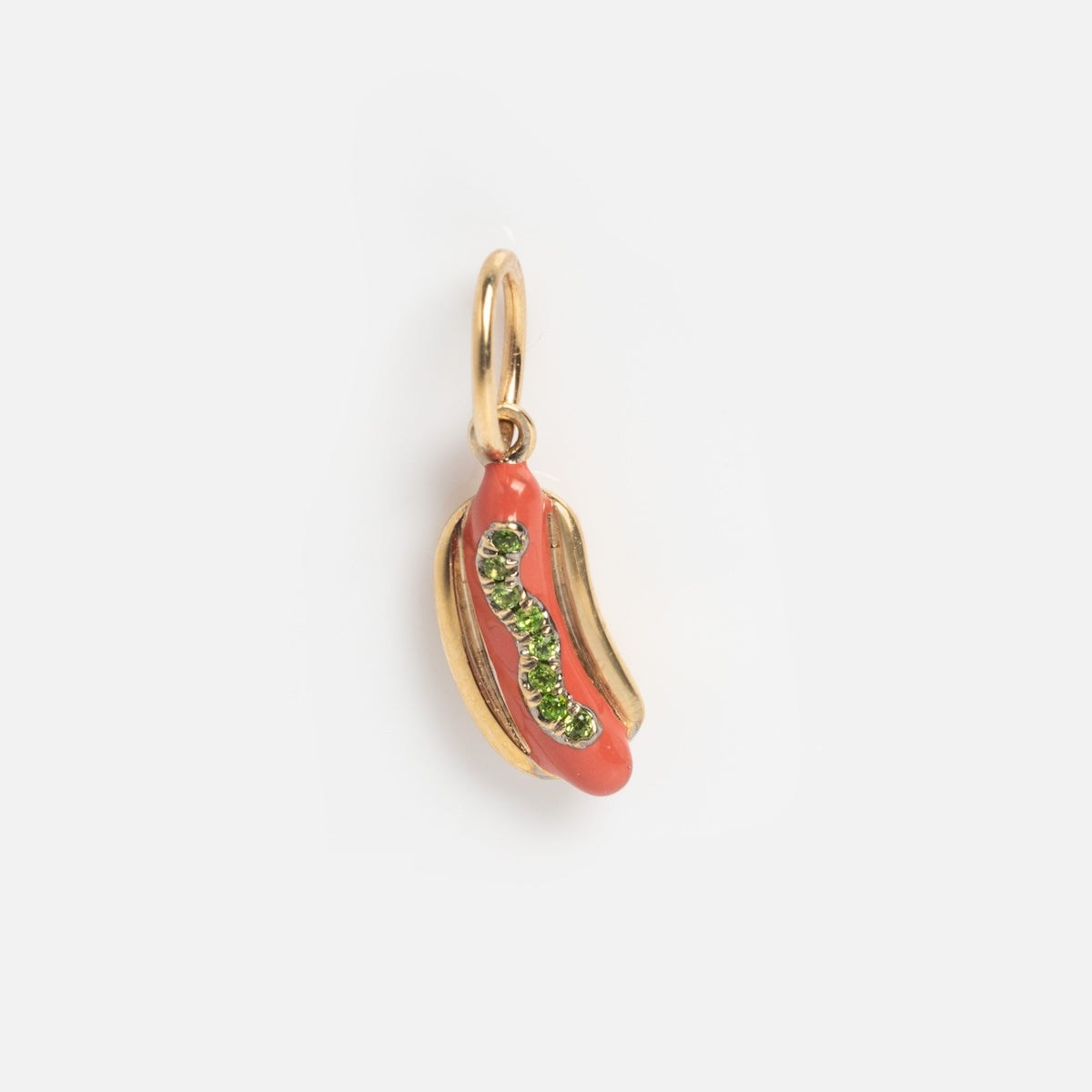 The Solid Gold Chicago Charm is shaped like a hot dog in a bun with red enamel for the sausage and green detailing for relish, shown on a plain white background.