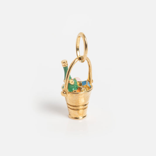 The Solid Gold Celebration Charm is a small 9k gold bucket holding a green and gold bottle, with a top loop for attaching to necklaces or bracelets—perfect for anyone seeking a festive solid gold charm.