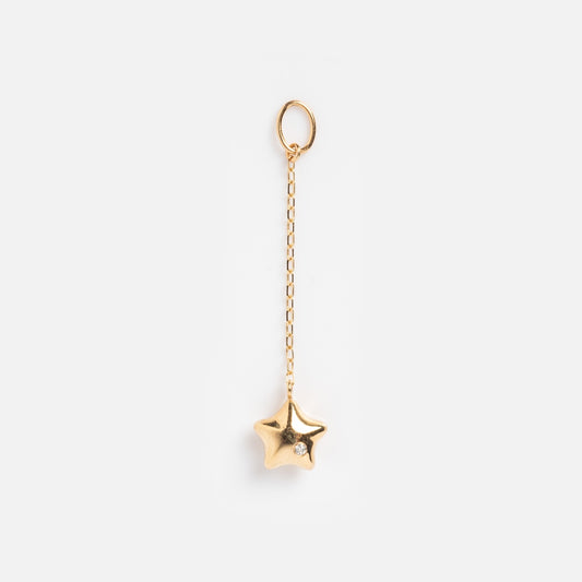The Solid Gold Statement Charm features a star-shaped gold pendant with a small gemstone, suspended from a delicate gold chain and circular loop—ideal for those seeking standout solid gold jewelry. Shown on a plain white background.