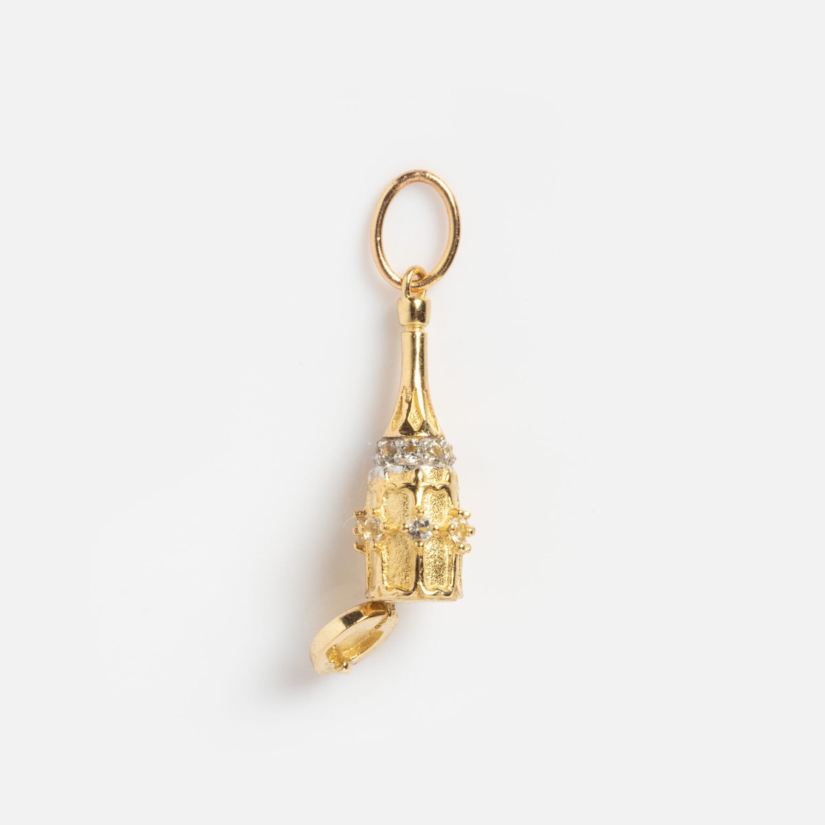 The Solid Gold Celebration Charm is a petite 9k gold cathedral tower with a hinged door and sparkling stone accents, finished with a round loop for easy hanging.