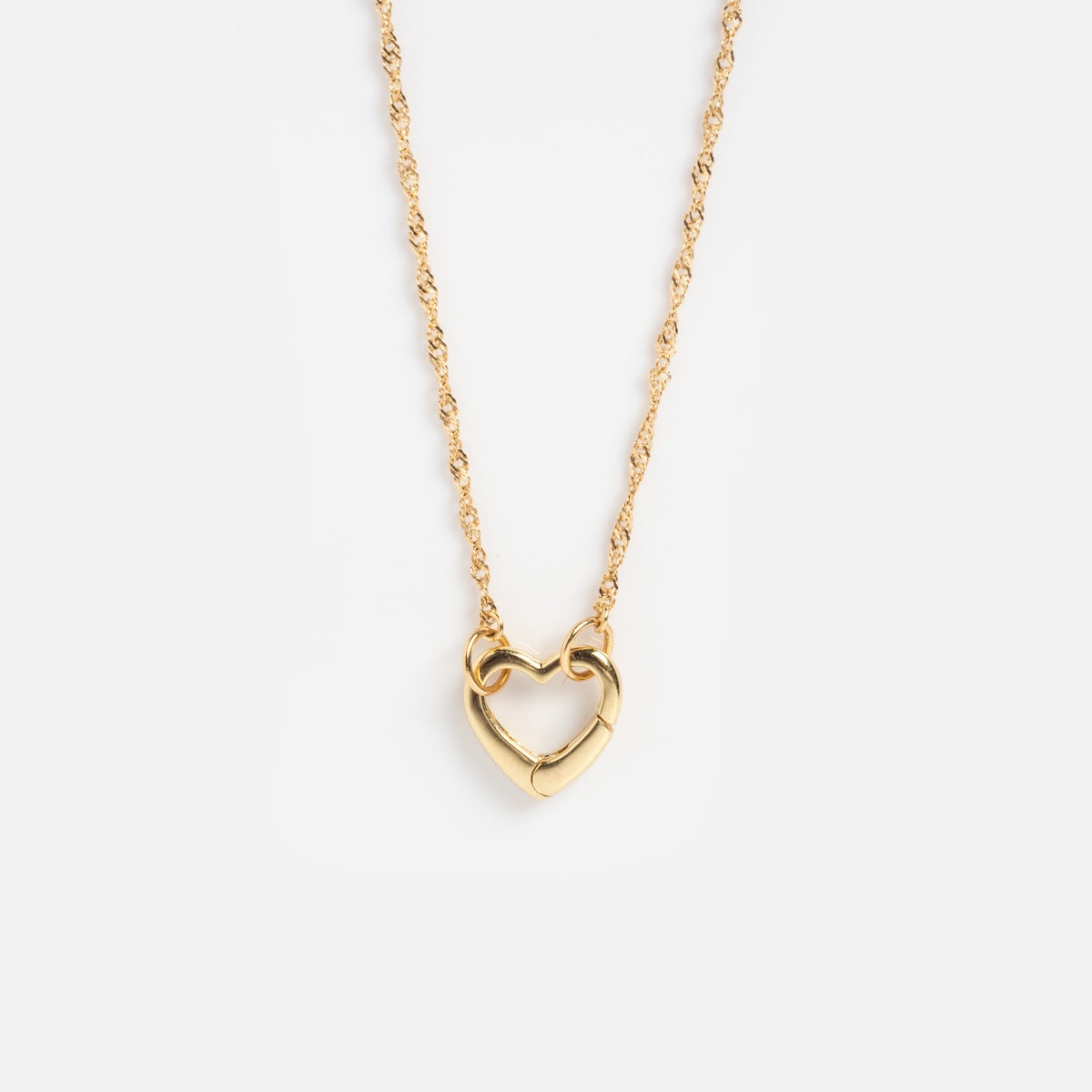 The Solid Gold Perfect Start Charm Holder Necklace features a twisted chain and heart-shaped pendant, showcased on a plain white background.