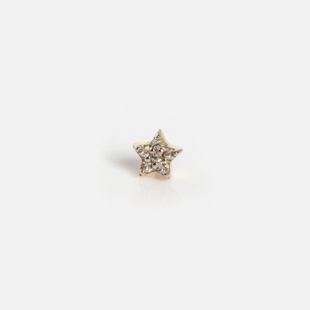 The Solid Gold Sparkling Star Flat Back Stud features a small, star-shaped gold design adorned with tiny clear crystals, shown against a plain white background.