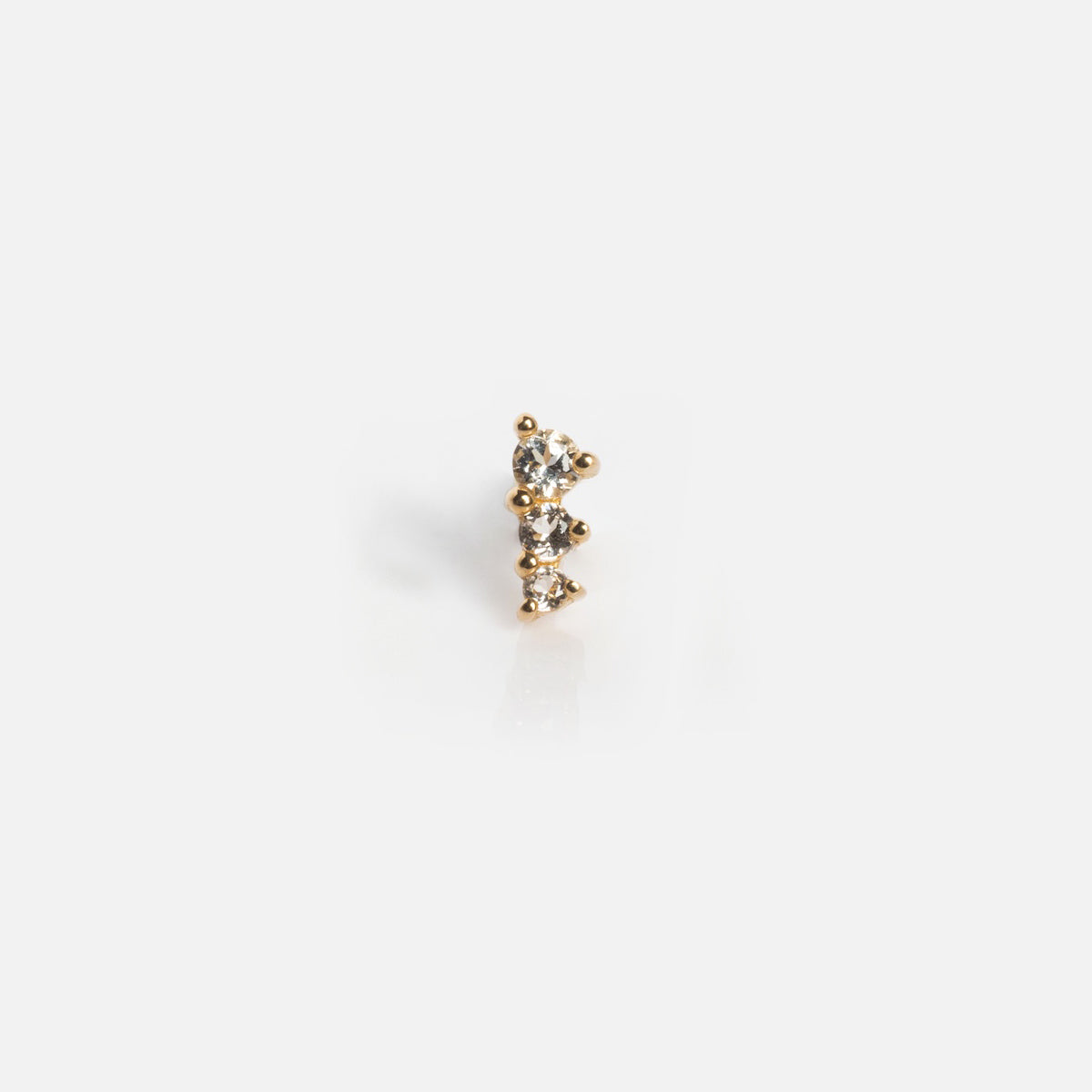The Solid Gold Tapered Shimmer Flat Back Stud features three clear gemstones aligned vertically, shown on a plain white background.