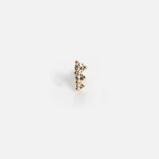 The Solid Gold Tapered Shimmer Flat Back Stud features three clear gemstones aligned vertically, shown on a plain white background.