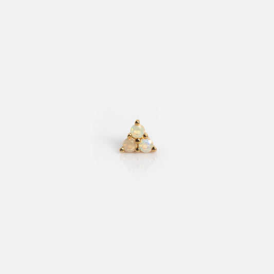 The Solid Gold Opal Trio Flat Back Studs are small gold earrings with three round, light opals set in a triangular design on a plain background.