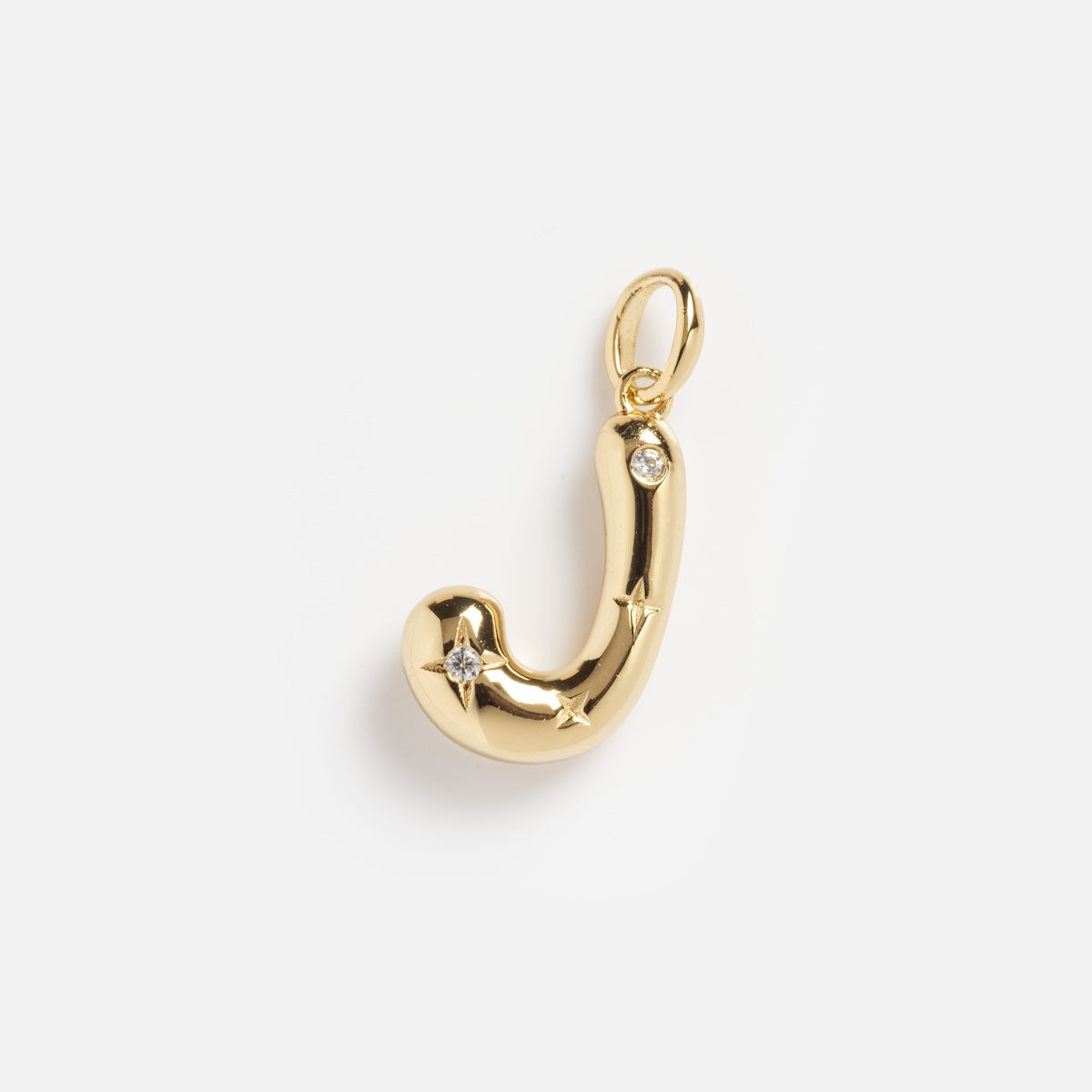The Star Crossed Celestial Bubble Letter Charm is a gold pendant in the shape of J, adorned with two small diamonds and a polished finish, displayed against a plain white background.