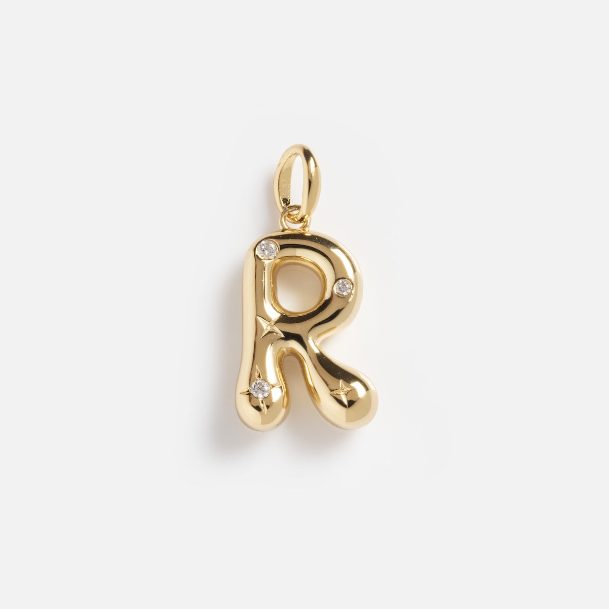 The Star Crossed Celestial Bubble Letter Charm is a gold pendant shaped like the letter R, featuring three small round gemstones and shown against a plain white background.