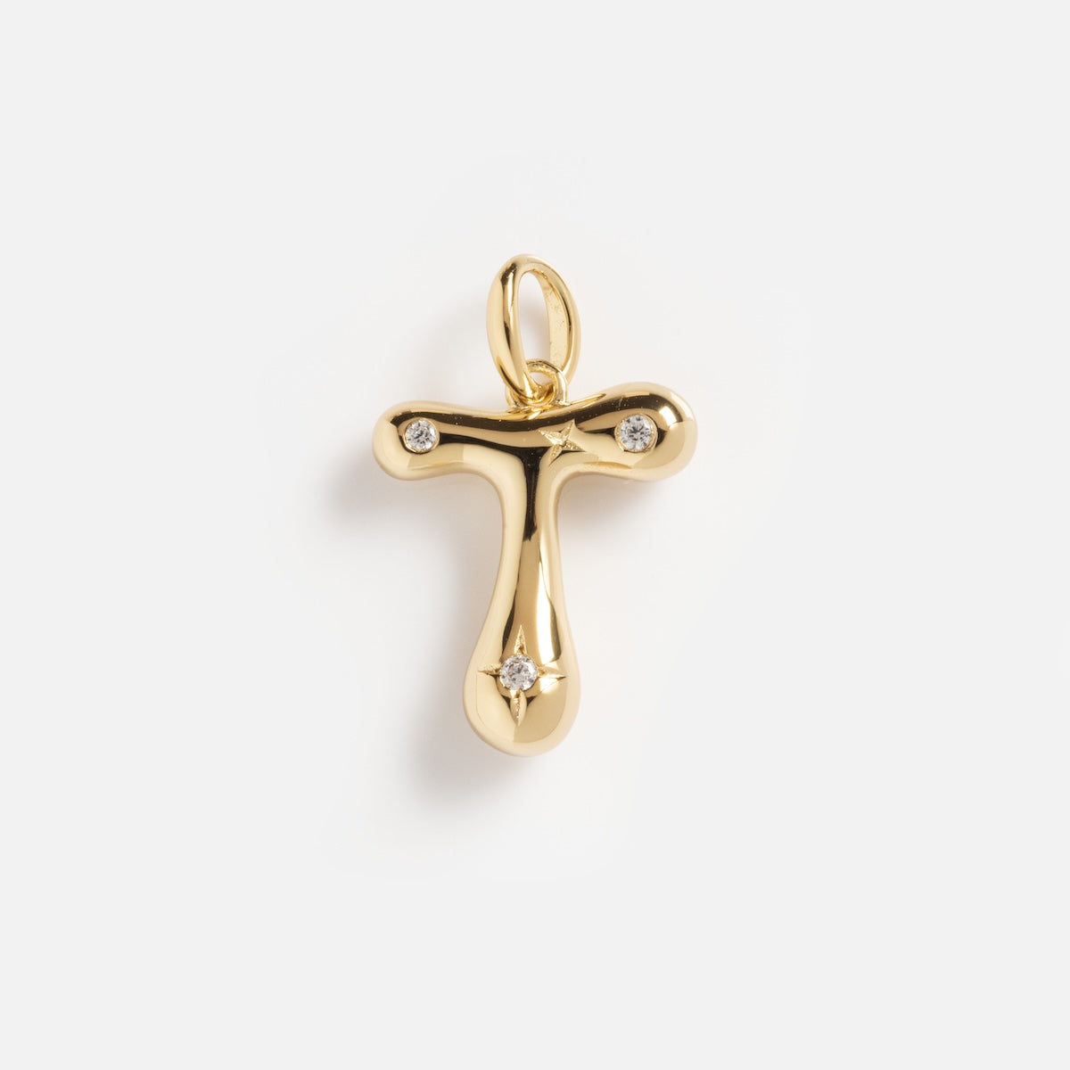 The Star Crossed Celestial Bubble Letter Charm is a gold T-shaped pendant with three small diamonds at the ends and center, shown against a plain white background.
