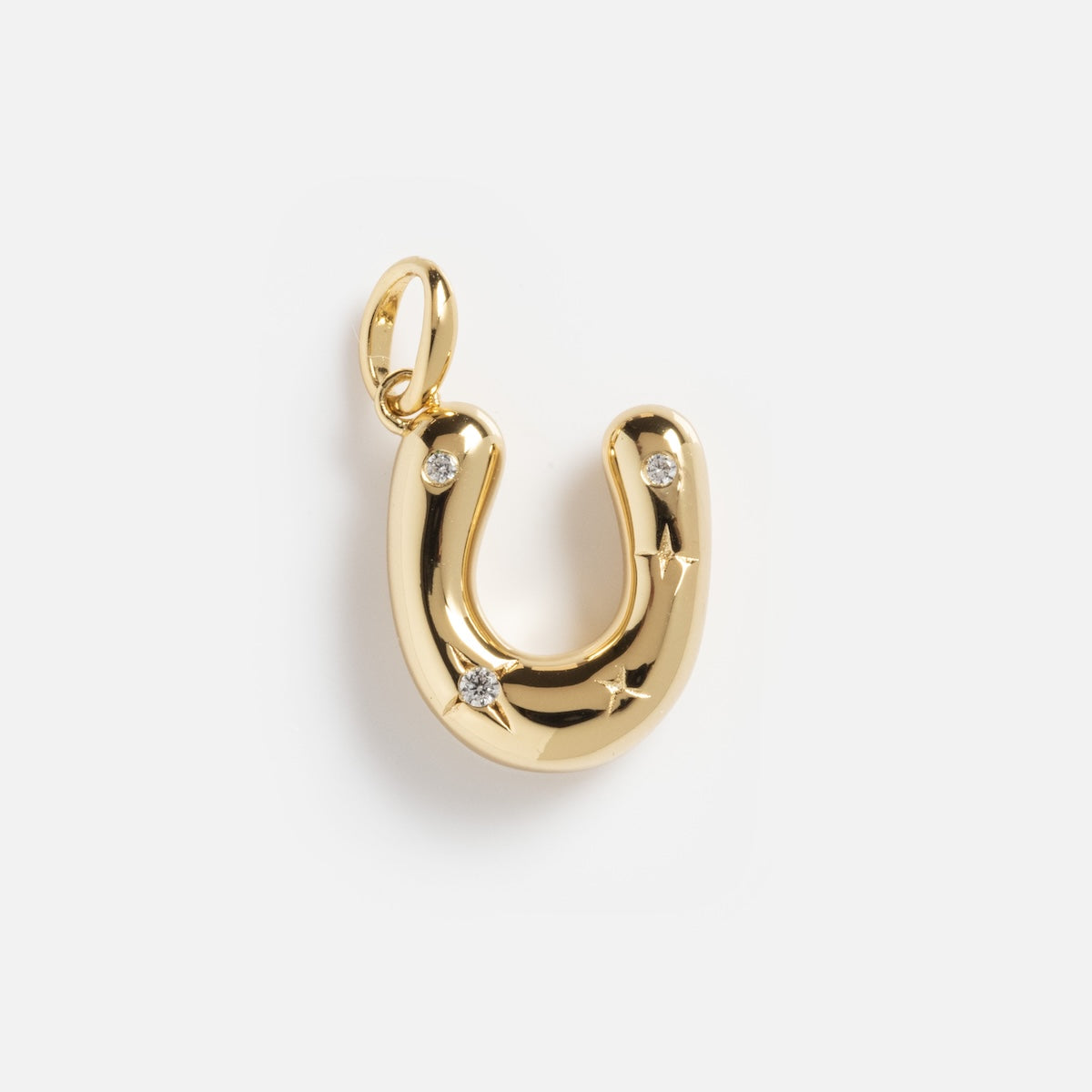The Star Crossed Celestial Bubble Letter Charm is a gold horseshoe-shaped pendant with three small embedded diamonds, shown on a white background.