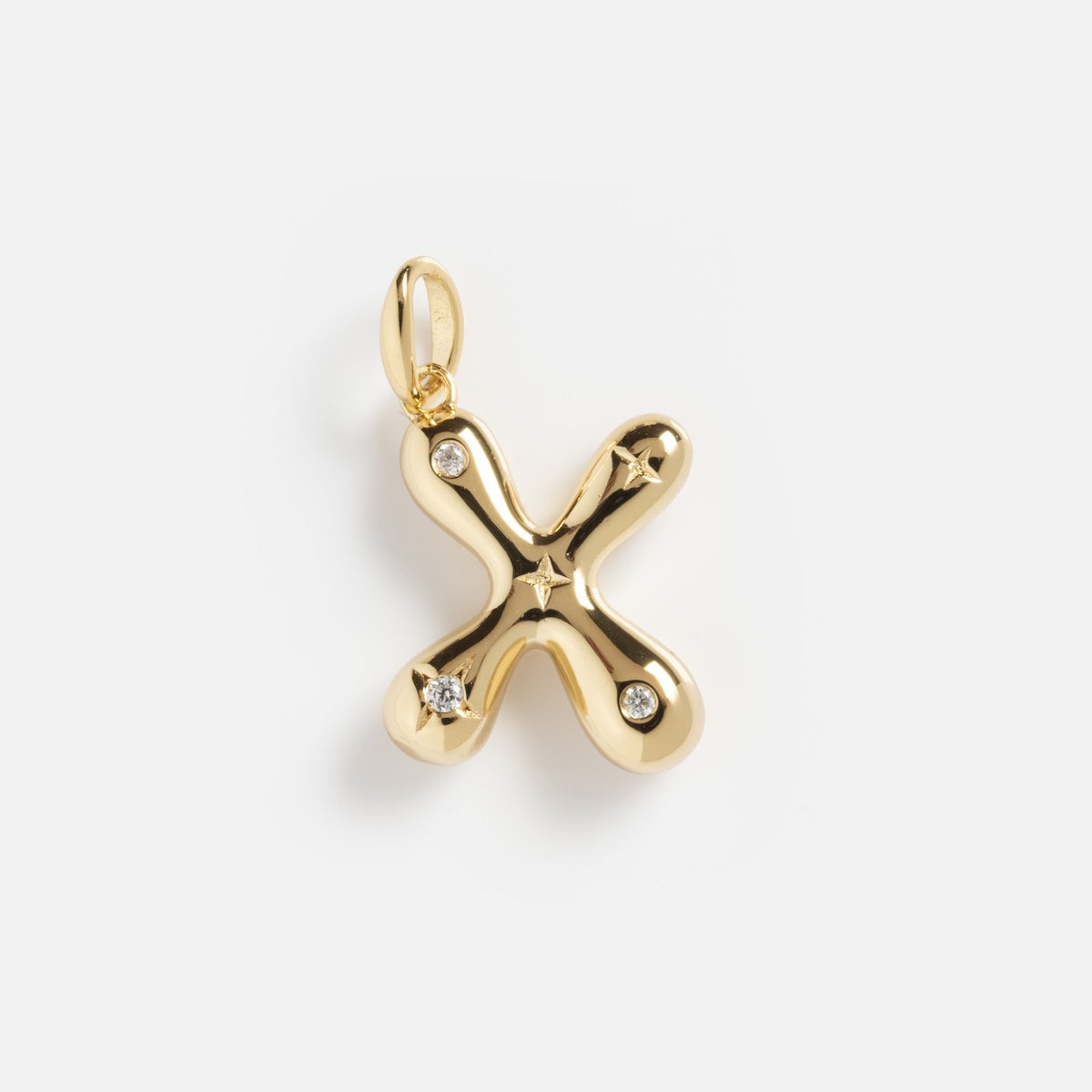 The Star Crossed Celestial Bubble Letter Charm is a gold X-shaped pendant with four small round diamonds at each tip, a star engraved in the center, a smooth polished finish, and a top loop for easy attachment.