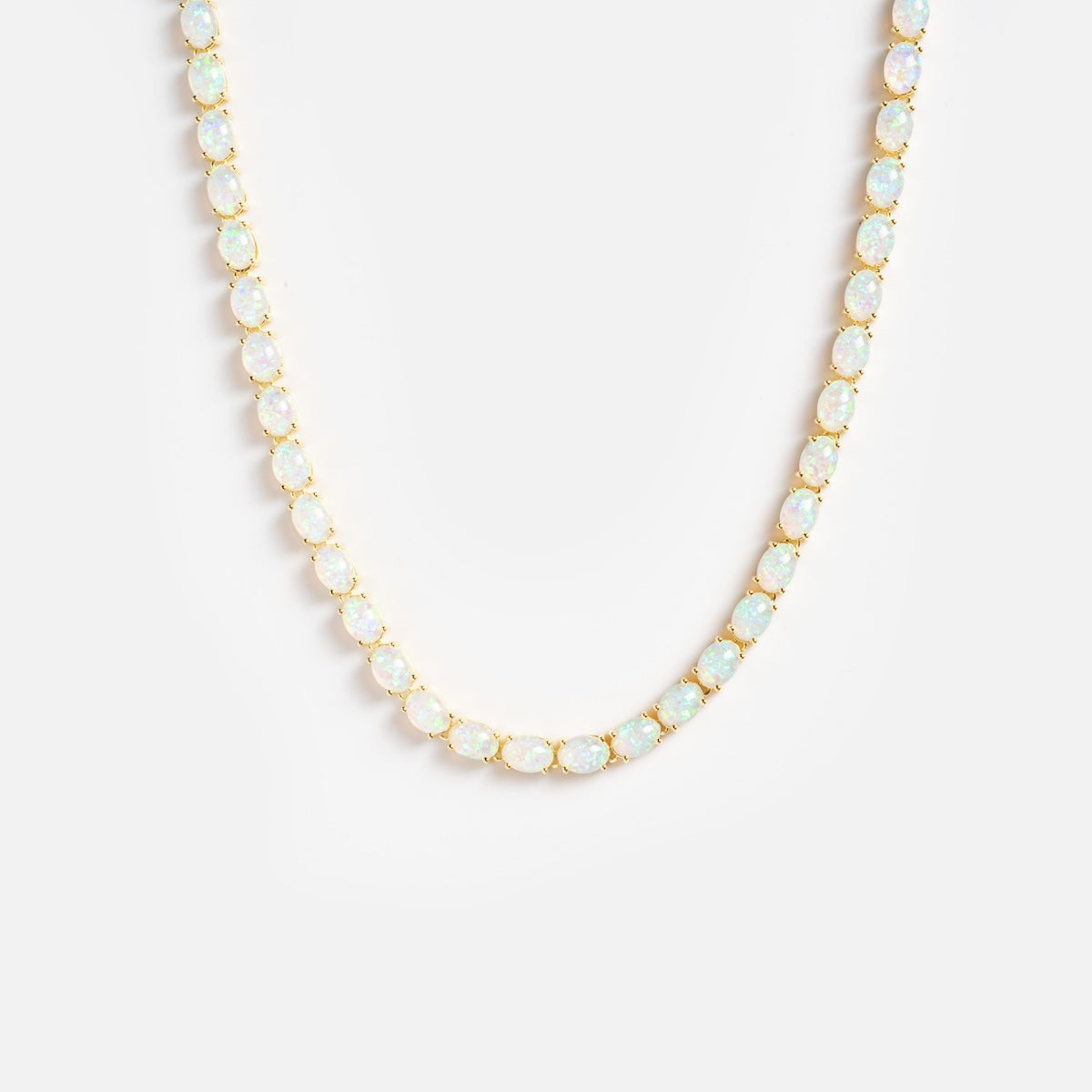 The Baby Blue Opal Eternal Tennis Necklace features oval opal gemstones evenly spaced along a gold chain, displayed on a plain white background.