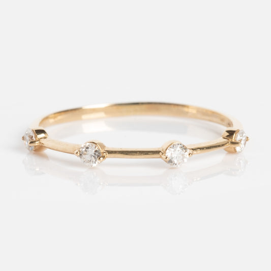 The Munro Ring is a thin gold band with five evenly spaced round diamonds, shown on a white background.