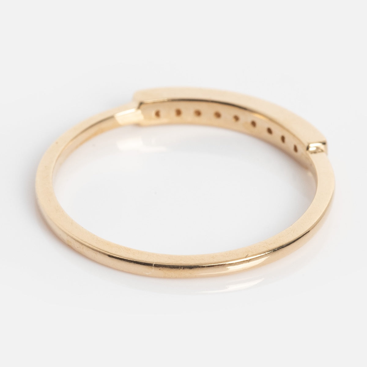 The Clyde Ring is a gold circular bracelet with a hinge and multiple adjustment holes, shown on a white background.