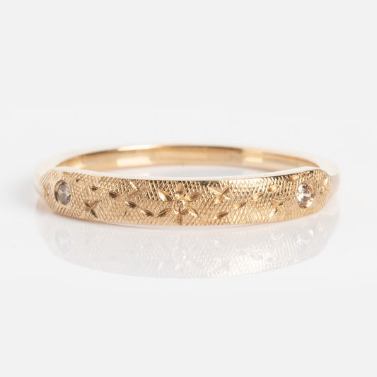 The Dukes Champagne Diamond Ring features an intricate, textured gold band with small champagne diamond-like stones set evenly around it, shown on a white background.