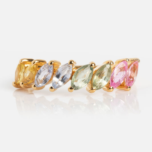 The Della Rainbow Sapphire Ring features six marquise-cut sapphires in yellow, blue, green, and pink, artfully arranged in a gradient on a gold band and photographed against a white background.