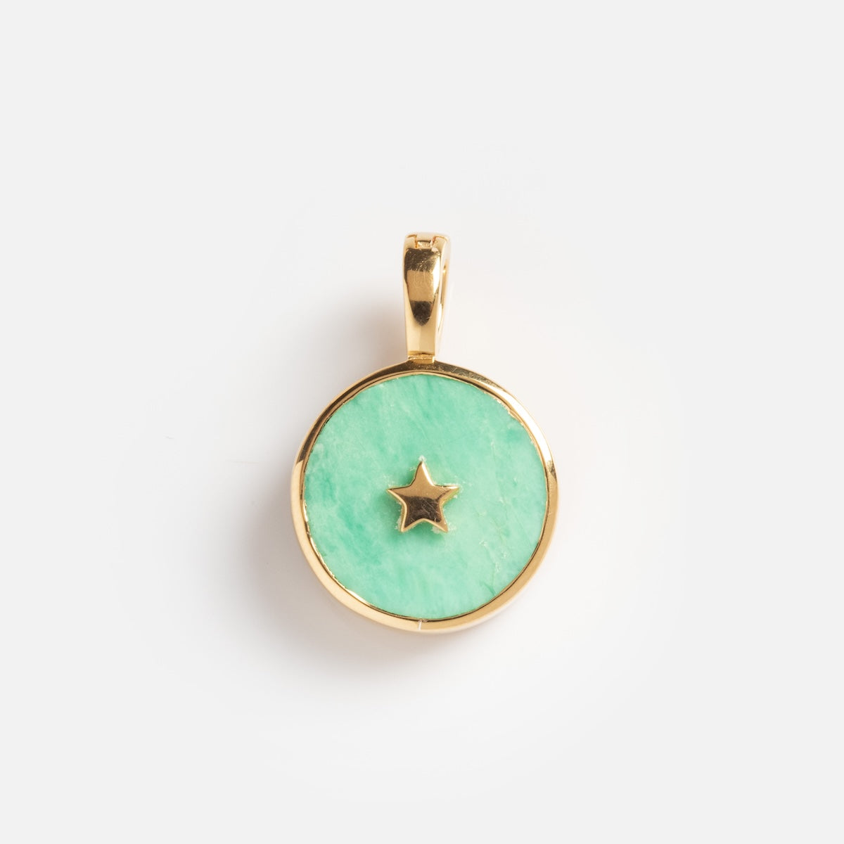 Charms by Carrie Elizabeth Jewelry: a round gold pendant with a light green center and a small gold star in the middle, shown on a plain white background.