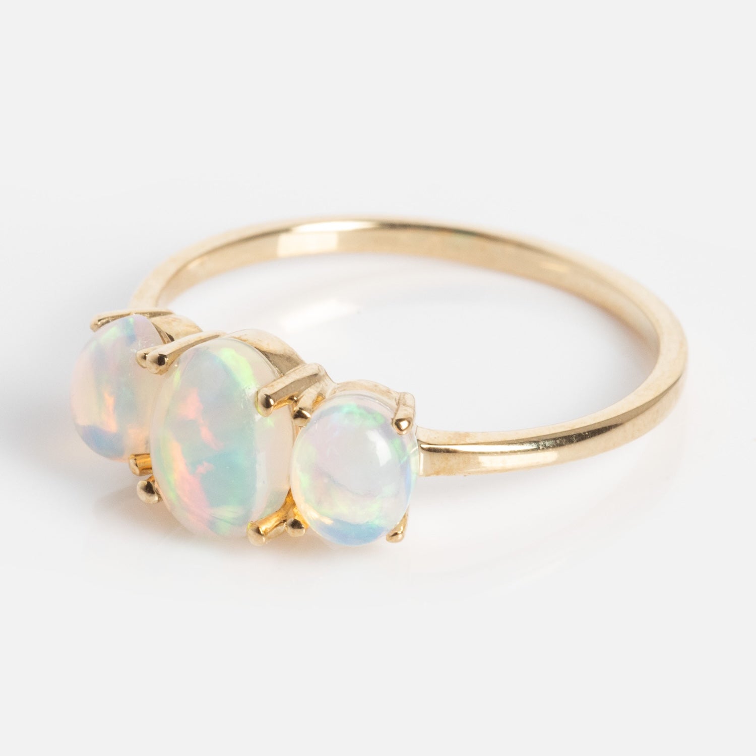 The Solid Gold 2025 October Capsule Classic Opal Trio Statement Ring features three oval opals of varying sizes, with the largest at the center and two smaller ones on each side, shown on a white background.